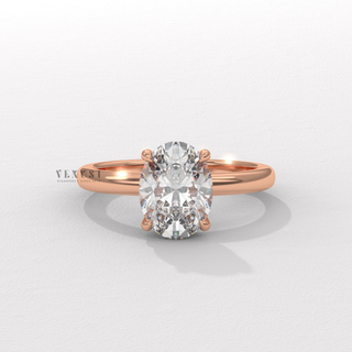 Front view of a oval cut moissanite engagement ring in a hidden halo solitaire setting up close