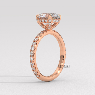Three-quarter angle of a oval cut moissanite engagement ring with a pave band