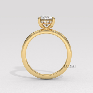 Side profile of a oval cut moissanite engagement ring in a hidden halo solitaire setting under bright light