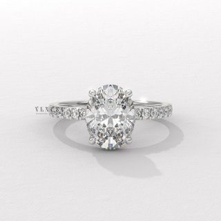 Front view of a oval cut moissanite engagement ring with a hidden halo and half pave band