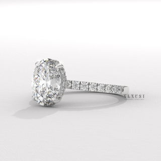 Close-up of a oval cut moissanite engagement ring with a hidden halo and half pave band