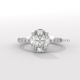 Full view of a oval cut moissanite engagement ring with a pave band with band detail