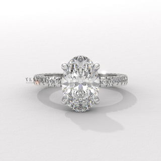 Lifestyle photo of a oval cut moissanite engagement ring with a hidden halo and pave band on the hand