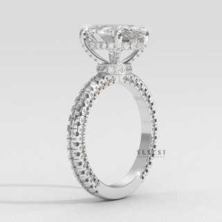 Front view of a oval cut moissanite engagement ring with a hidden halo and pave band from the left