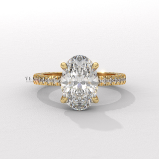Centre-stone close-up of a oval cut moissanite engagement ring with a hidden halo and pave band