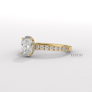 Oval cut moissanite engagement ring with a hidden halo and half pave band shown on a finger