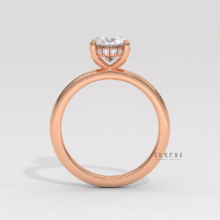 Side profile of a oval cut moissanite engagement ring in a hidden halo solitaire setting in fine detail