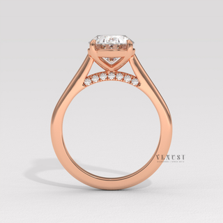 Close-up of a oval cut moissanite engagement ring in a hidden halo solitaire setting