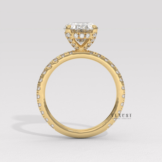 Oval cut moissanite engagement ring with a pave band worn on a hand
