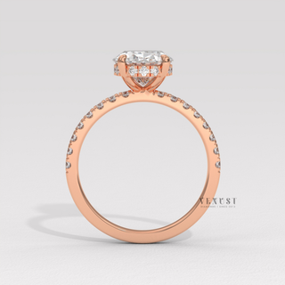 Front view of a oval cut moissanite engagement ring with a hidden halo and half pave band under soft light