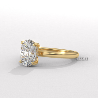 Front view of a oval cut moissanite engagement ring in a hidden halo solitaire setting from a low angle