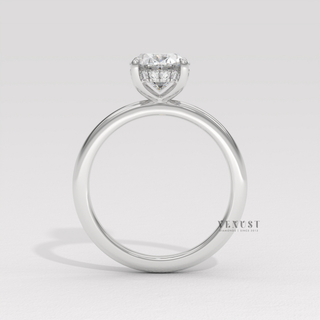 Side profile of a oval cut moissanite engagement ring in a hidden halo solitaire setting up close