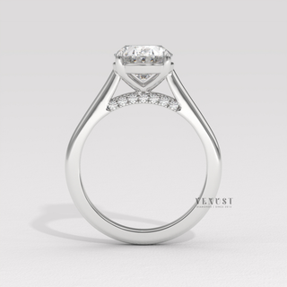 Three-quarter angle of a oval cut moissanite engagement ring in a hidden halo solitaire setting