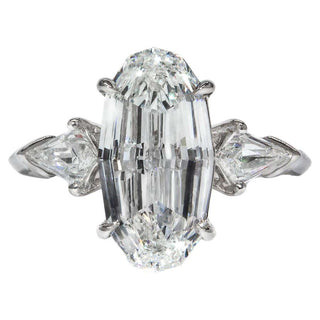 Oval step cut three stone moissanite engagement ring front view