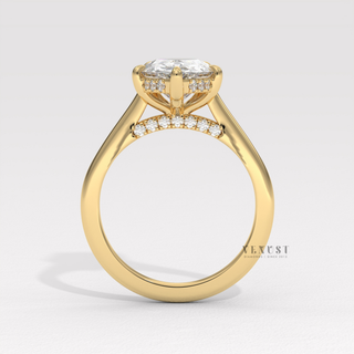 Lifestyle photo of a pear cut moissanite engagement ring with a hidden halo and cathedral setting on the hand