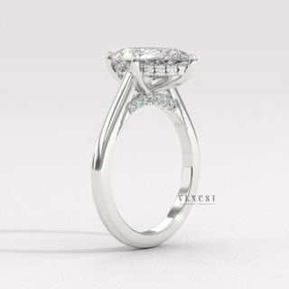 Low-angle view of a pear cut moissanite engagement ring with a hidden halo and cathedral setting