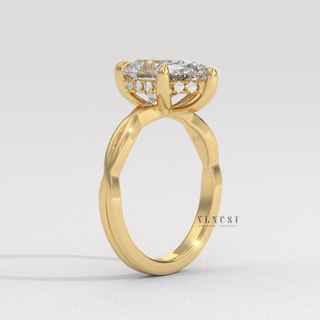 Side profile of a pear cut moissanite engagement ring on an infinity band