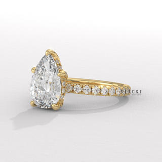 Full view of a pear cut moissanite engagement ring with a pave band with band detail