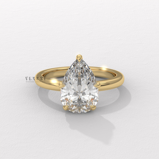 Pear cut moissanite engagement ring in a hidden halo solitaire setting worn on a hand
