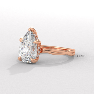Full view of a pear cut moissanite engagement ring on an infinity band with band detail