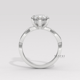 Pear cut moissanite engagement ring on an infinity band worn on a hand