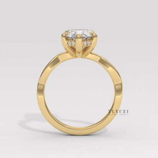 Three-quarter angle of a pear cut moissanite engagement ring on an infinity band