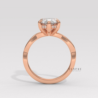 Macro shot of the centre stone on a pear cut moissanite engagement ring on an infinity band
