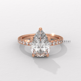 Lifestyle photo of a pear cut moissanite engagement ring with a pave band on the hand
