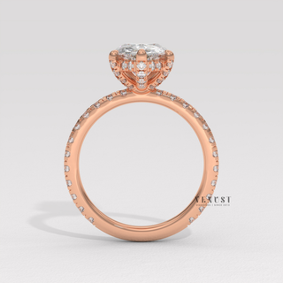 Pear cut moissanite engagement ring with a pave band worn on a hand