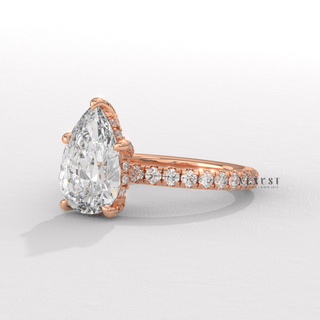 Front view of a pear cut moissanite engagement ring with a pave band