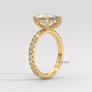 Top-down view of a pear cut moissanite engagement ring with a pave band