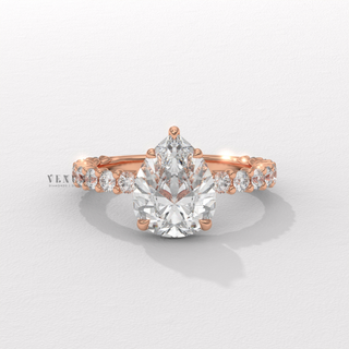 Pear cut moissanite ring with three quarter pave detail