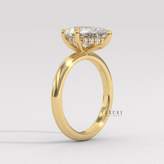 Detailed setting shot of a pear cut moissanite engagement ring in a hidden halo solitaire setting