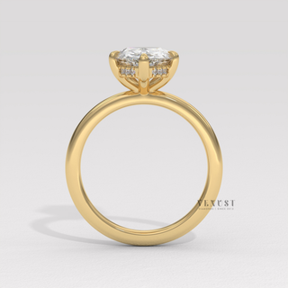 Centre-stone close-up of a pear cut moissanite engagement ring in a hidden halo solitaire setting