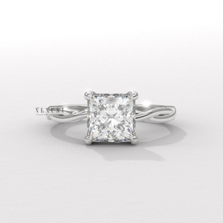 Profile shot of a princess cut moissanite engagement ring on an infinity band and its band