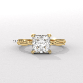 Low-angle view of a princess cut moissanite engagement ring on an infinity band