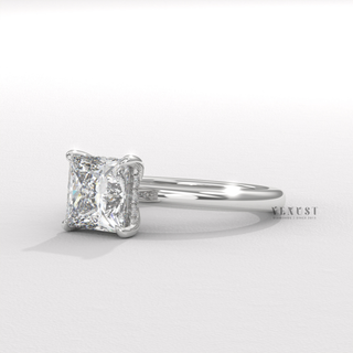 Overhead close-up of a princess cut moissanite engagement ring in a hidden halo solitaire setting