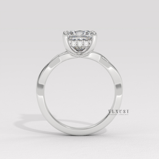 Princess cut moissanite engagement ring on an infinity band photographed on a white background