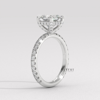 Close-up of a princess cut moissanite engagement ring with a hidden halo and pave band