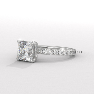 Front view of a princess cut moissanite engagement ring with a hidden halo and pave band