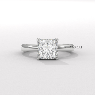 Hand model wearing a princess cut moissanite engagement ring in a hidden halo solitaire setting