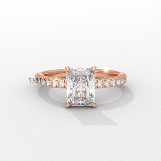 Angled view of a radiant cut moissanite engagement ring with a pave band catching the light