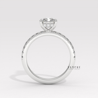 Full view of a radiant cut moissanite engagement ring with a pave band with band detail