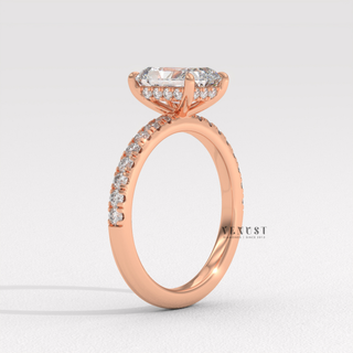 Studio shot of a radiant cut moissanite engagement ring with a pave band on a plain backdrop