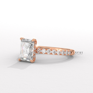 Tilted view of a radiant cut moissanite engagement ring with a pave band showing its sparkle