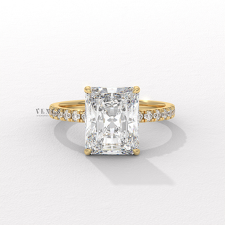 Front view of a radiant cut moissanite engagement ring with a hidden halo and pave band