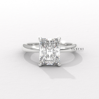 Studio shot of a radiant cut moissanite engagement ring in a hidden halo solitaire setting on a plain backdrop