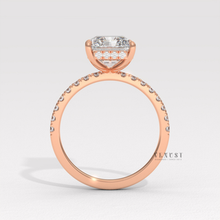 Front view of a radiant cut moissanite engagement ring with a hidden halo and pave band under soft light