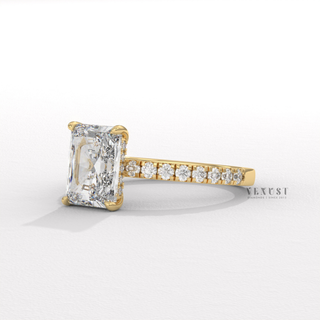 Tilted view of a radiant cut moissanite engagement ring with a hidden halo and pave band showing its sparkle