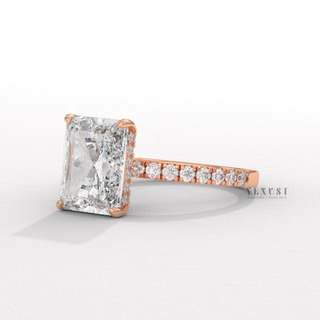 Three-quarter angle of a radiant cut moissanite engagement ring with a hidden halo and pave band